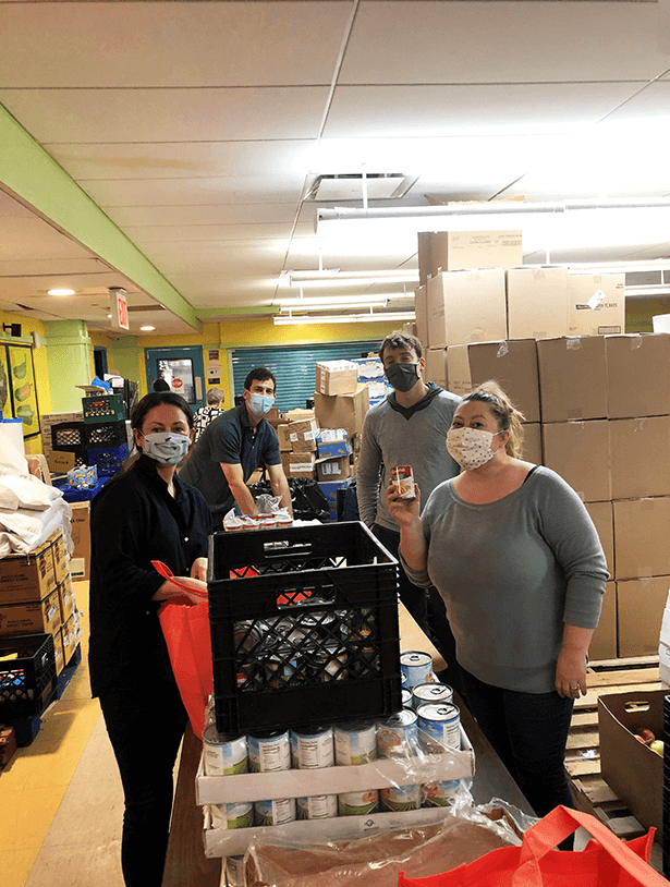MicrosoftTeams-image-1 A group of colleagues gather canned food for charity.