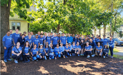 Large group of Viking team members volunteering outdoors.